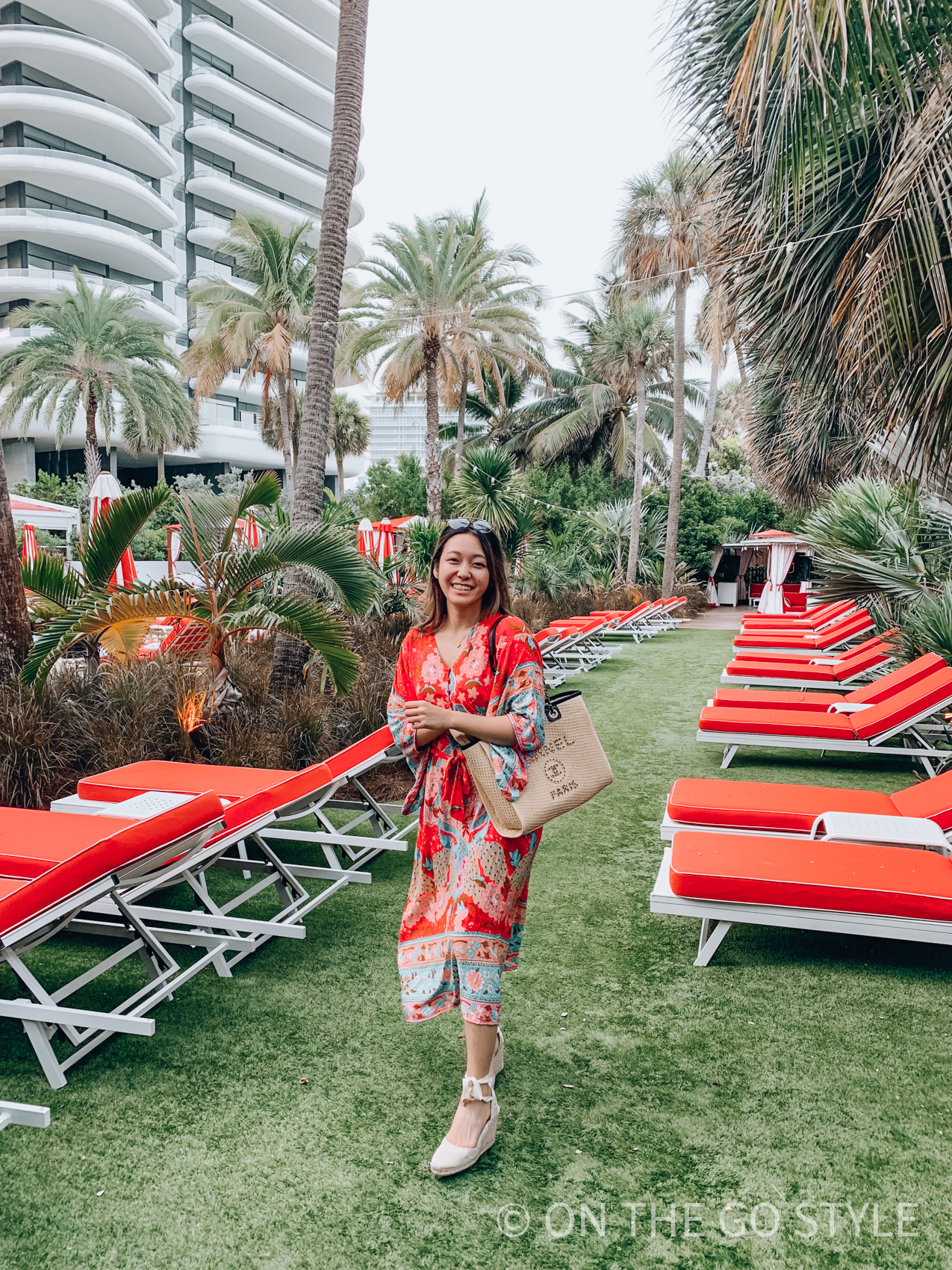 Faena Miami poolside palm trees and umbrellas - Chanel raffia Deauville tote
