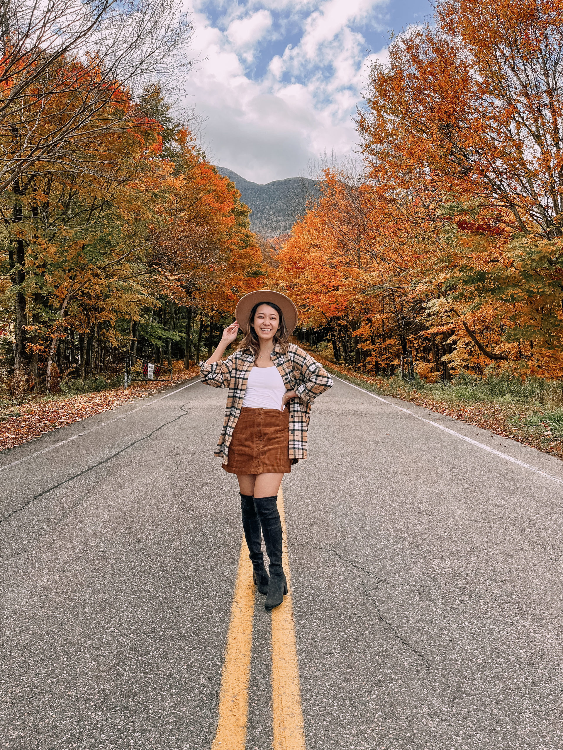 Plaid shacket and over the knee boots in middle of road Smuggler's Notch 